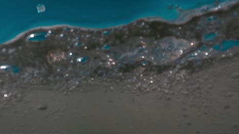 Half-underwater-first-person-view-of-sea-waves-splashing-on-camera