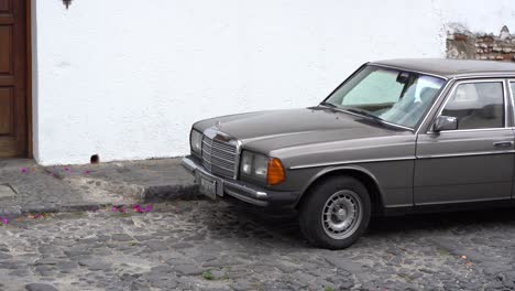 An-old-mercedes-benz-parked-in-the-streets-of-Antigua,-Guatemala