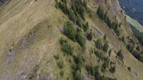 Man-running-on-tightrope-walk-towards-a-mountain-peak-in-Switzerland