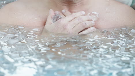 Cropped-Portrait-Of-A-Man-Submerged-In-Cold-Water-With-Ice-Cubes