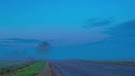 Misty-Road-With-Traveling-Cars-During-Daylight.-Timelapse