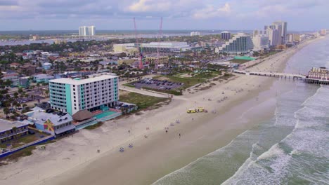 Aerial-drone-reveal-of-Daytona-beach-coastline-on-a-sunny-summer-day