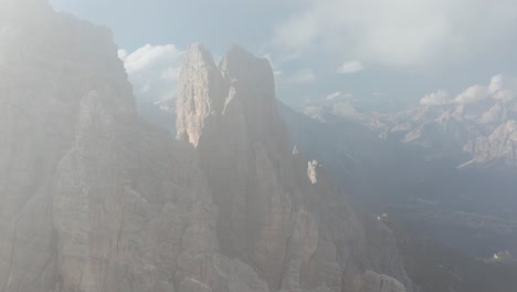 Flight-through-thin-clouds-to-reveal-jagged-peaks-of-Croda-da-Lago-mountain---epic-rugged-landscape-in-Italian-Dolomites