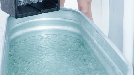 Putting-Ice-Cubes-Into-Ice-Bath-Tub-With-Water