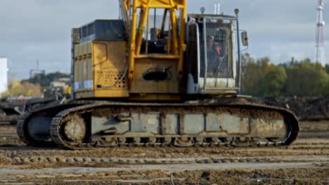 Static-Shot-Of-Mobile-Crane-Compacting-Soil-In-Slow-Motion