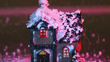 Snow-landing-on-a-miniature-Christmas-house