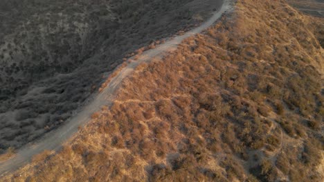 Aerial-view-of-bike-trails-on-top-of-a-mountain-at-sunset