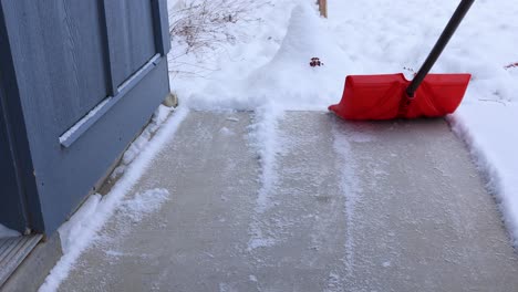 Shoveling-Snow-off-of-Porch-During-Winter