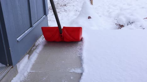 Shoveling-Snow-from-Sidewalk-in-Front-of-House