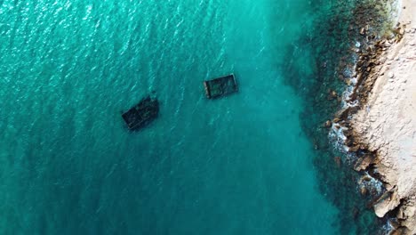 Top-down-aerial-view-of-archeological-structures-immersed-in-turquoise-water