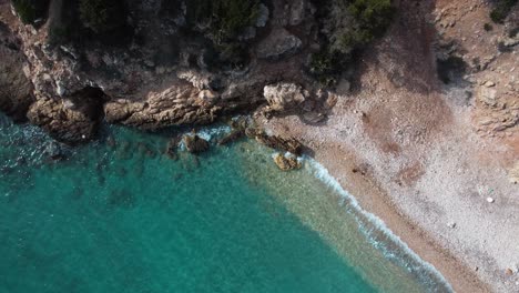Paradisiac-secluded-bay-beach-with-clear-turquoise-sea-water,-overhead-aerial