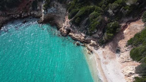 Dream-vacation-beach-bay,-turquoise-Sardinian-water,-aerial-drone-view,-day