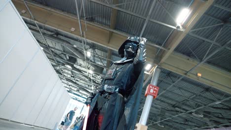Cinematic-shot-of-Darth-Vader-raising-and-pumping-his-fist-at-a-cosplay-convention