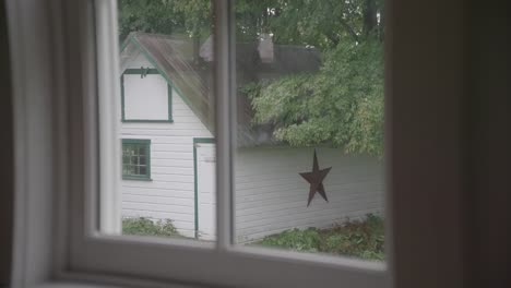 a-window-view-of-a-house-with-a-star-on-it