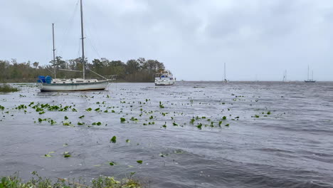 Sailboats-anchored-in-rough-waters-before-hurricane-storm-with-masts-down