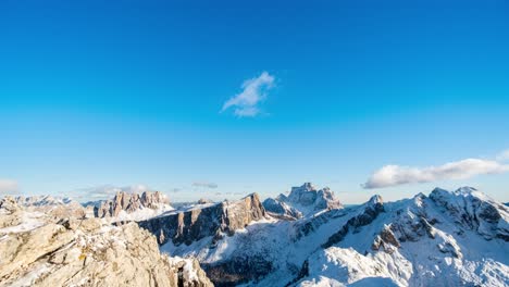 Time-lapse:-White-Clouds-moving-at-blue-sky-over-snowy-peaks-of-Dolomites-in-summer