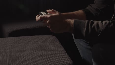 Wide-view-of-male-hands-playing-with-videogame-controller-and-dropping-controller-in-frustration