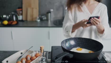 Woman-taking-photos-for-Instagram-while-baking-an-egg,-doing-shoots-from-different-angles