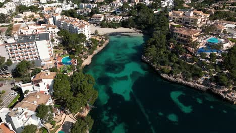 Aerial-view-of-drone-flying-to-a-beach-in-Cala-d'Or-on-Mallorca-during-summer-holiday