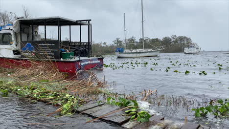 Hurricane-storm-aftermath-flooding-over-seawalls-while-damaging-scuba-boat