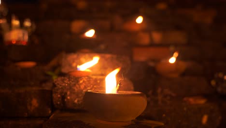 Close-up-of-traditional-stone-candles-burning-during-Yi-Peng-Festival-in-Thailand