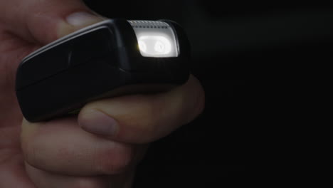 Close-up-of-turning-a-car-emergency-flashlight-on-and-off