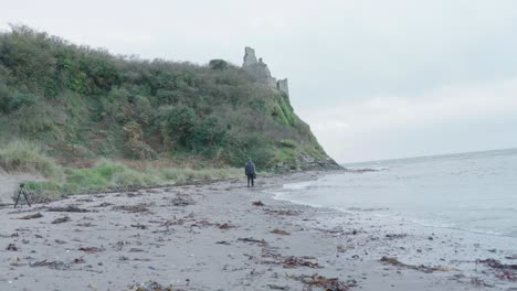 A-Videographer-near-the-sea-shore-on-location
