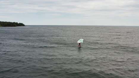 Aerial,-active-person-wing-surfing-on-Lake-Superior-on-a-gloomy-overcast-day