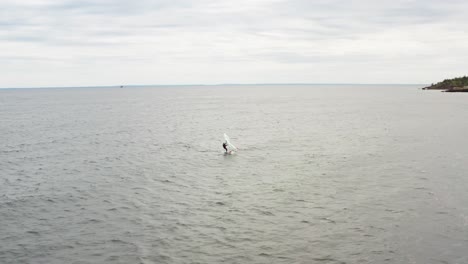 Aerial,-active-person-wing-foil-surfing-on-Lake-Superior-on-a-gloomy-overcast-day