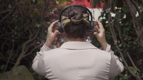 Girl-Placing-Headphones-On-Her-Head-In-Nature