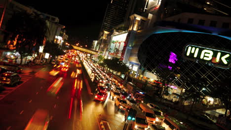 MBK-street-in-Bangkok,-time-lapse-with-lights-and-people-in-traffic
