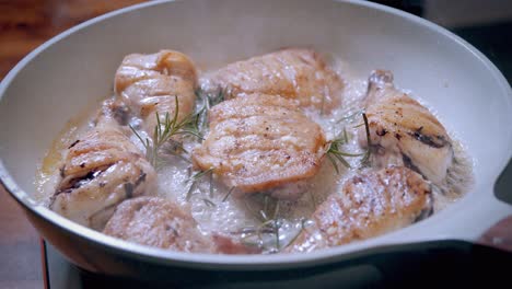 Golden-Brown-Fried-Chicken-Cooking-in-Pan-with-Garlic-Sauce-and-Herbs