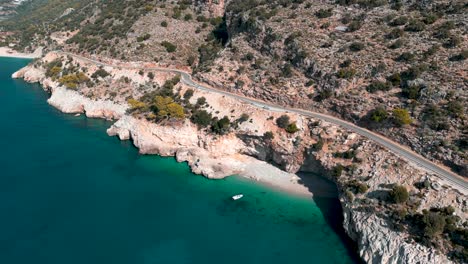 a-boat-on-a-hidden-blue-water-beach-in-the-Turkish-coast---South-of-Turkey,-Fethieye