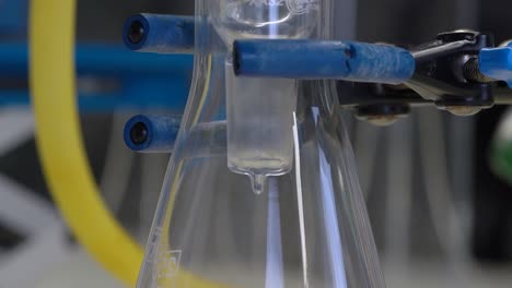 Chemistry-equipment,-close-up-of-liquid-dripping-into-a-receiving-flask-during-distillation