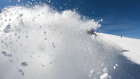 Caucasian-man-spray-fresh-snow-powder-at-camera-on-ski-slope,-slow-motion