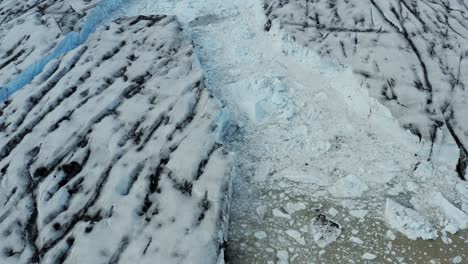 Aerial-over-glacier-with-floating-ice-in-glacial-lake---Vatnajokull,-Iceland