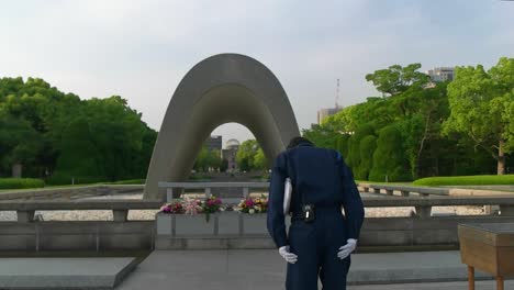 Japanese-police-officer-paying-respects-in-front-of-peace-memorial-park-in-Hiroshima