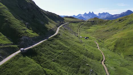 RV-Motorhome-drives-Mountain-Pass-in-Savoy-Isere,-French-Alps---Aerial-Follow