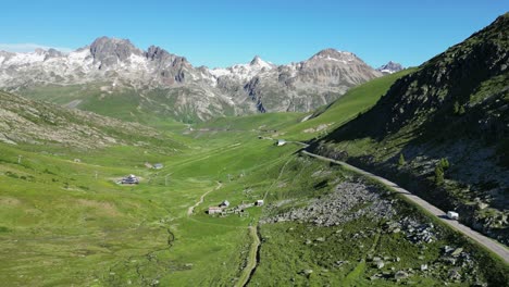 RV-Motorhome-drive-Col-de-la-Croix-de-Fer-Mountain-Pass-in-French-Alps---Aerial-Follow