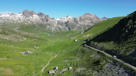 RV-Motorhome-drives-Col-de-la-Croix-de-Fer-Mountain-Pass-in-French-Alps---Aerial-Follow
