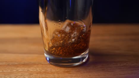 Cold-coffee-being-poured-into-a-pint-class-in-slow-motion