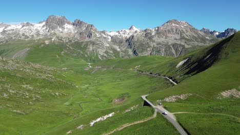 Motorhome-RV-drives-Mountain-Pass-in-Savoy-Isere,-French-Alps---Aerial-Dolly-Follow