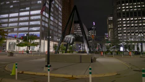 Joe-Louis-fist-statue-in-Detroit,-Michigan-with-gimbal-video-walking-forward-at-night