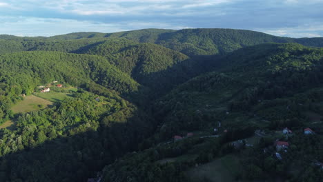 Beautiful-Green-Forested-Mountains,-Aerial-Establishing,-Sunny-Day