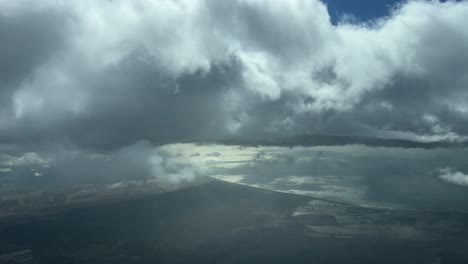 Pilot-point-of-view-from-a-jet-cockpit-flying-over-the-Gufl-of-Cadiz,-Spain,-during-descent-through-some-stratus-clouds