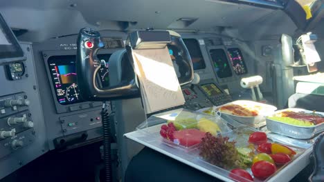 Close-view-of-a-pilot-eating-his-crewmeal-in-flight-during-the-cruise-level,-daylight