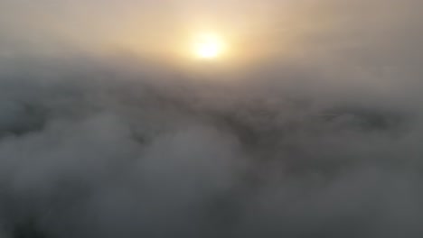 Aerial-rising-above-the-clouds-to-an-amazing-sunrise