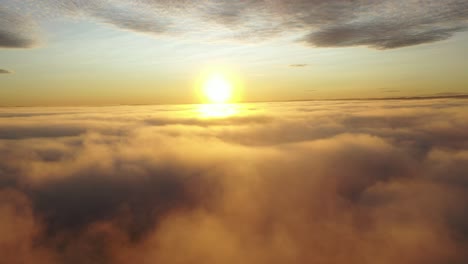 Drone-shot-in-the-cloud-revealing-the-sun-above-the-clouds