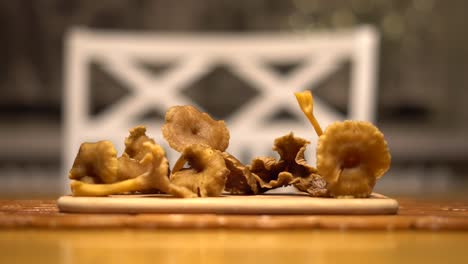 putting-down-a-funnel-chanterelle-mushroom-on-a-table