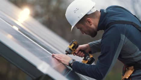 Portrait-of-a-male-solar-panel-installer-with-a-cordless-screwdriver